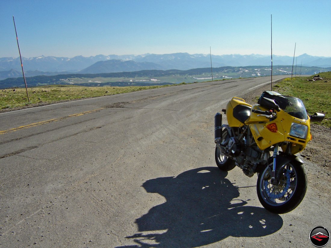Yellow Ducati 900 SuperSport on the top of a mountain