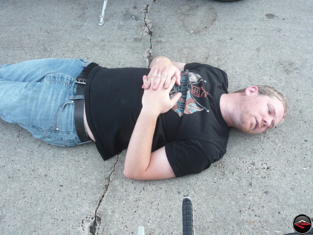 Man laying down in a parking lot