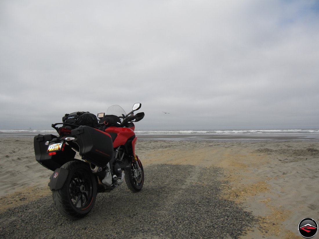 2012 Red Ducati Multistrada 1200 S Touring with luggage parked on the beach