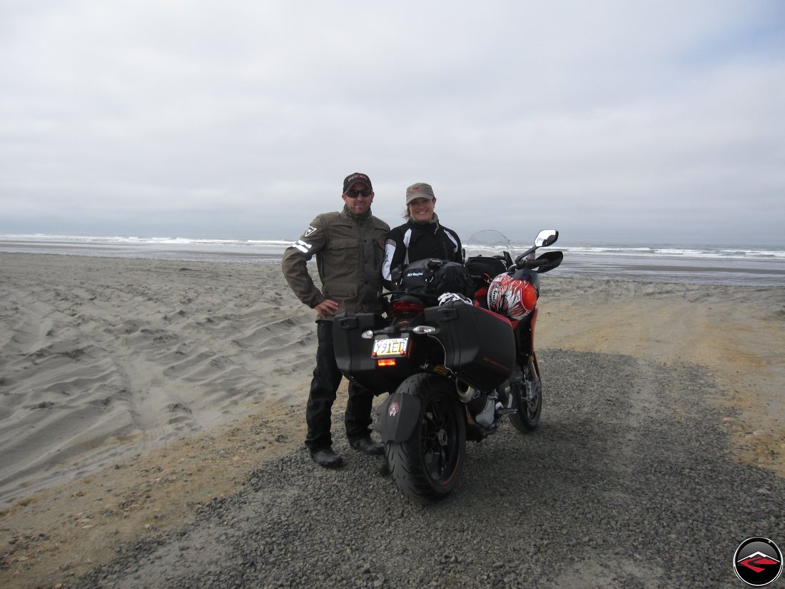 Ducati Motorcycle Riders with Multistrada parked on the beach portrait