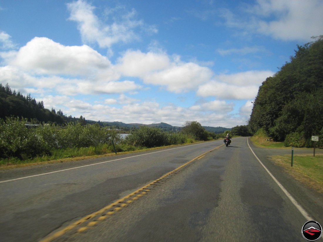 Motorcycle riding along washington highway 101 along the pacific coast