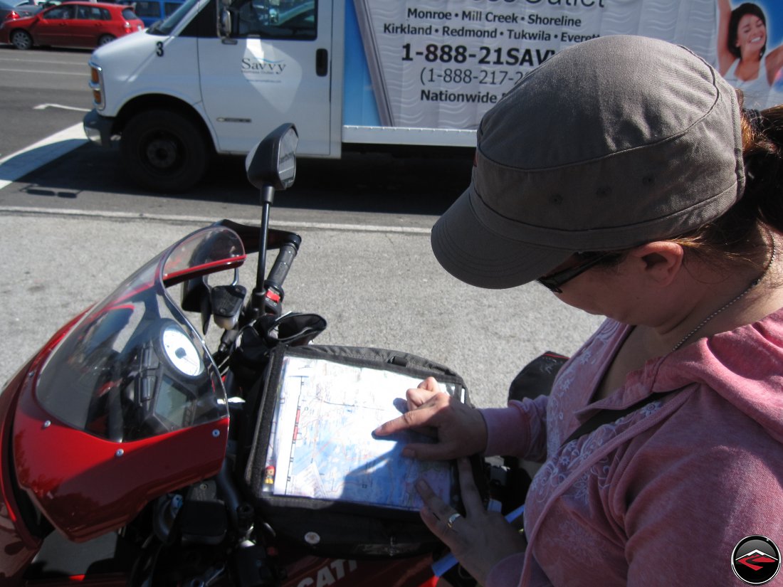 Looking at map in a motorcycle tank bag