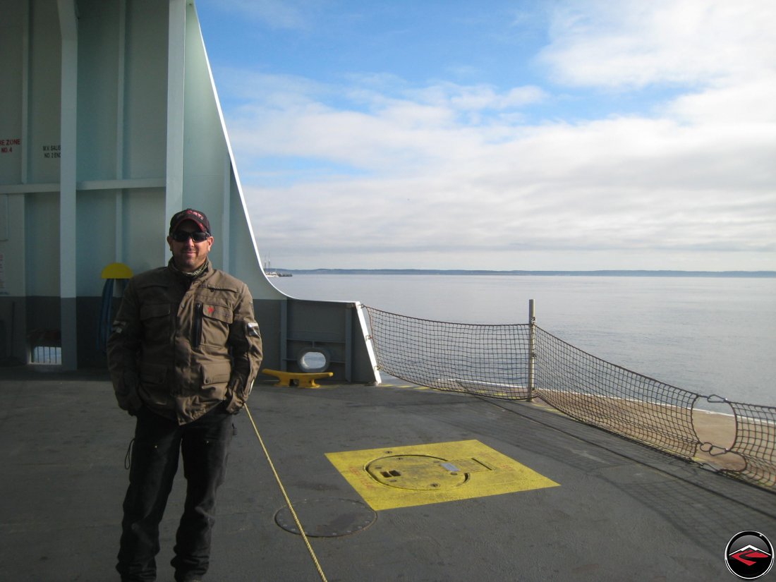 man standing on the bow of a ferry boat