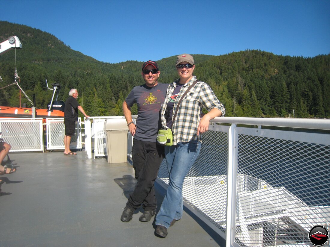 Man and woman standing on the deck of a ferry boat