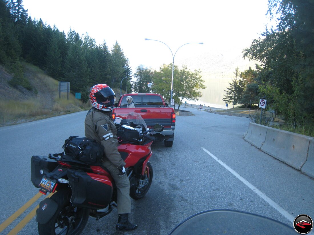 Queue for a ferry with a dog in the back of a pickup