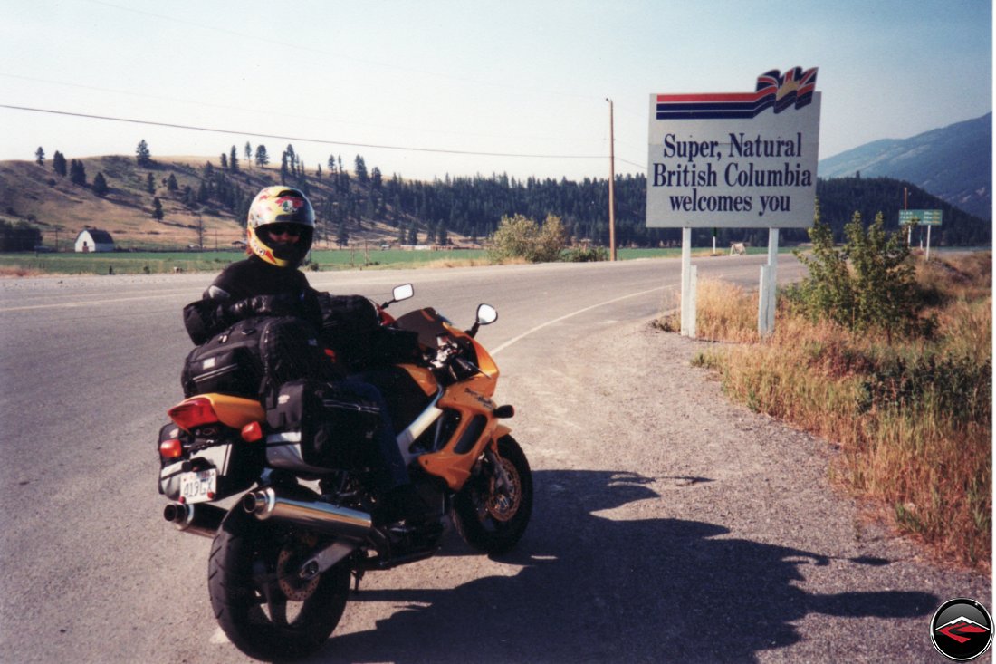 Honda Superhawk motorcycle entering British Columbia canada at the Roosvill border sign Welcome to Canada