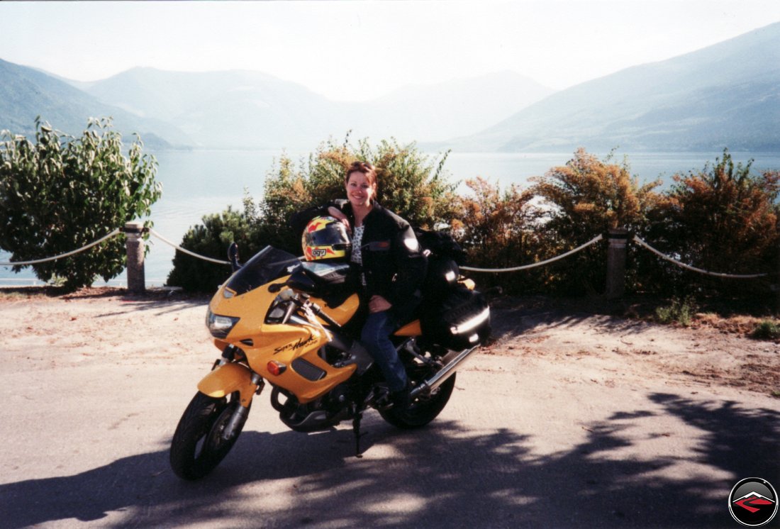 super pretty and sexy girl kris sitting on her yellow honda vtr1000 superhawk in nakusp british columbia