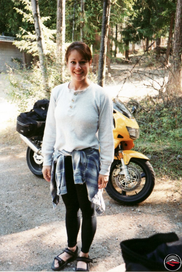 super pretty sexy girl standing in front of her motorcycle wearing yoga pants