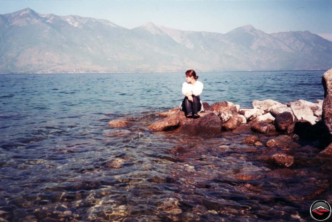 pretty girl sitting on the rocks in british columbia