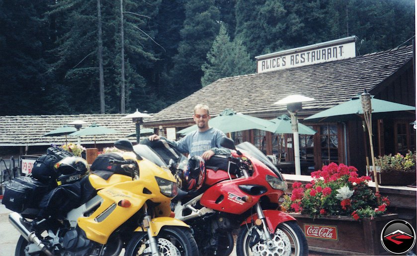 Man standing behind Yellow Honda VTR10000 Superhawk and Suzuki TL1000S at Alices Retaurant on Skyline Boulevard in Northern California