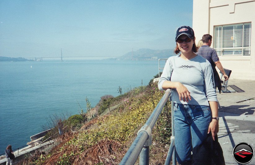 Pretty girl with the Golden Gate Bridge visible from Alcatraz Island
