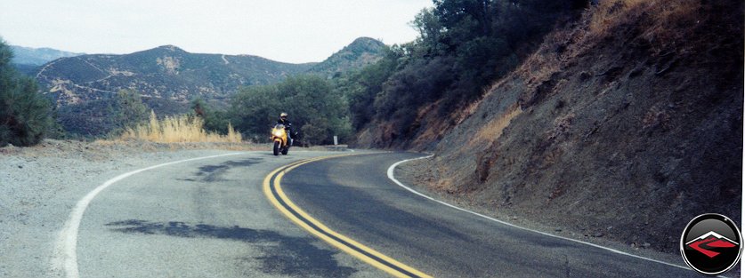 Kris cornering on her yellow VTR1000 SuperHawk