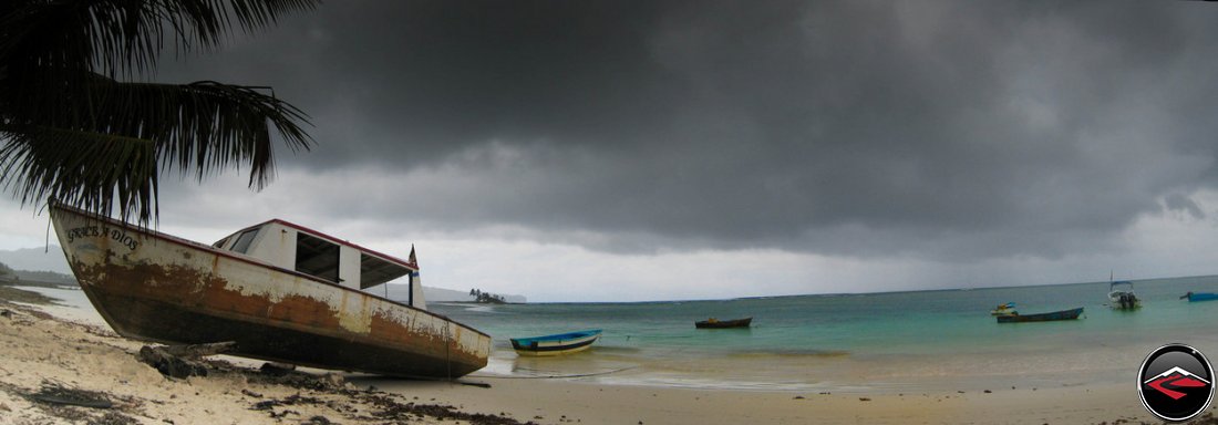 Grace A Dios old fishing boat and storm clouds in the caribbean