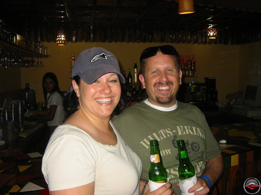 man and woman drinking presidente beer