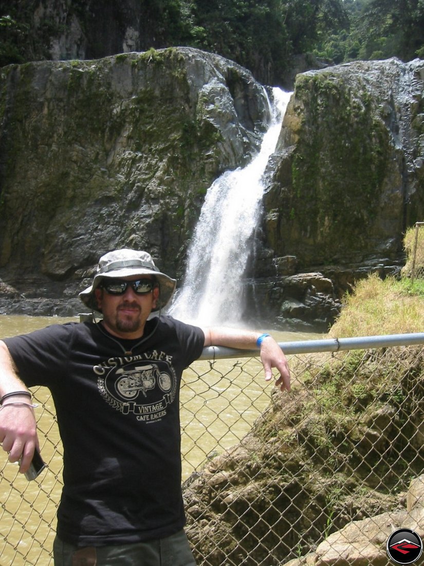 man in front of a waterfall