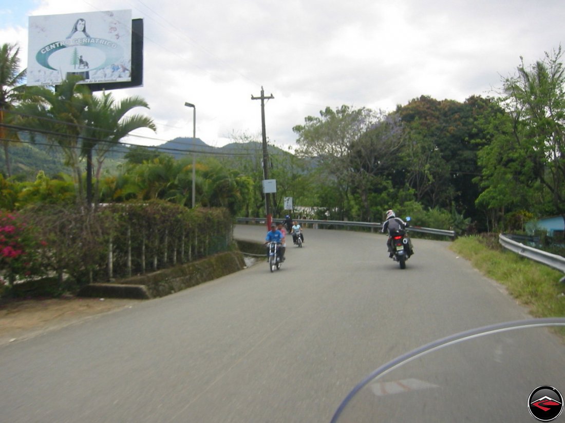 riding a motorcycle around a corner in the Dominican Republic