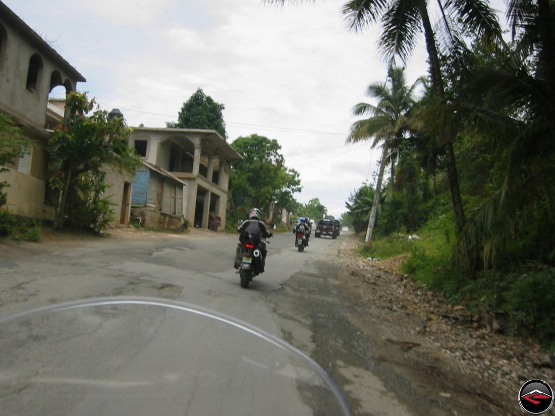 riding a motorcycle over a patchy road in samana dominican republic