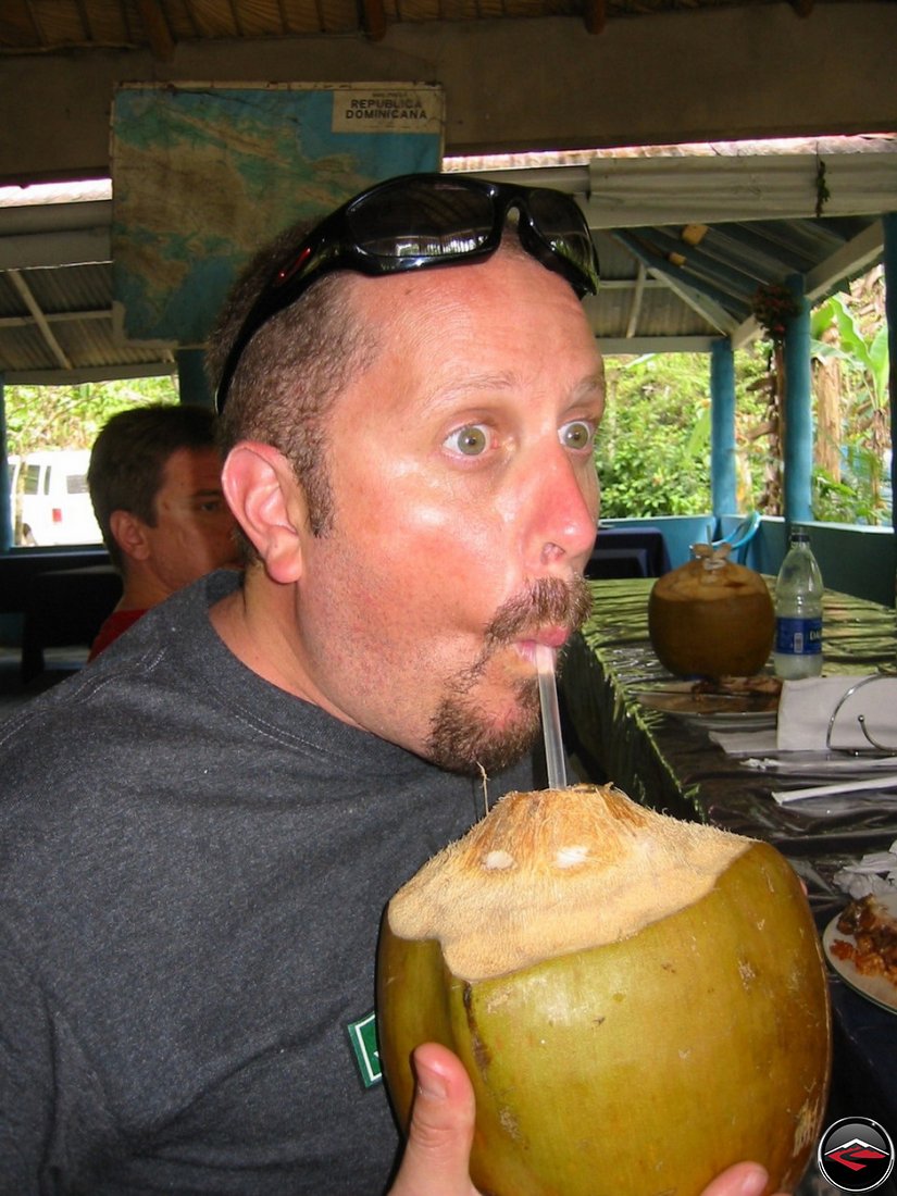 drinking coconut milk out of a coconut at Cascada El Limon Dominican Republic