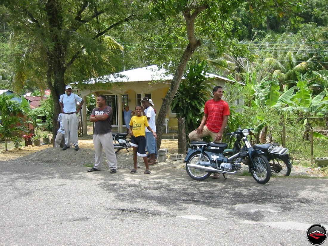 local people in the dominican republic watching people drive by