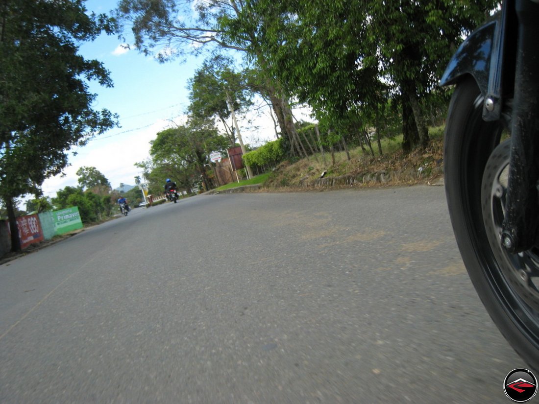 Suzuki V-Strom 650 Motorcycle Front wheel riding down a caribbean road