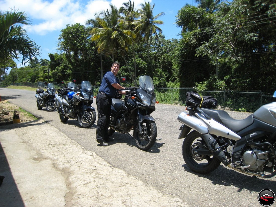 Suzuki V-Strom 650 motorcycles parked along the side of the road on a caribbean island