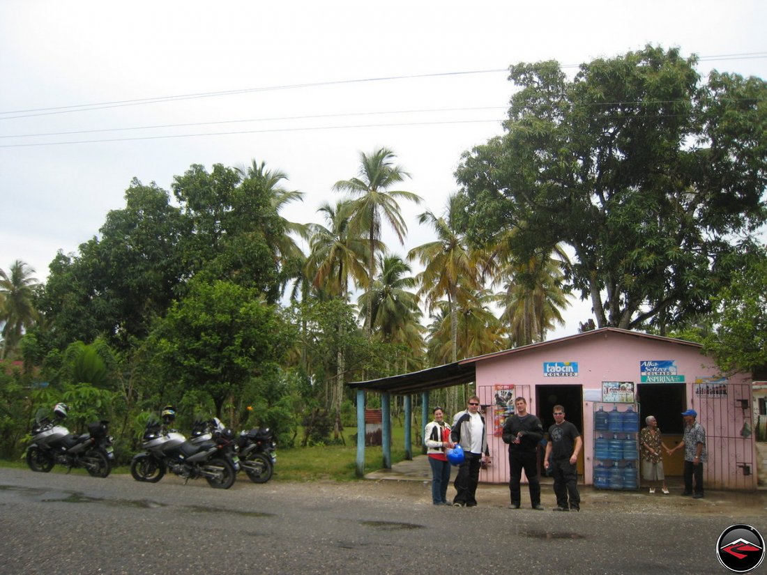 small, pink, roadside convienence store along the road in the caribbean