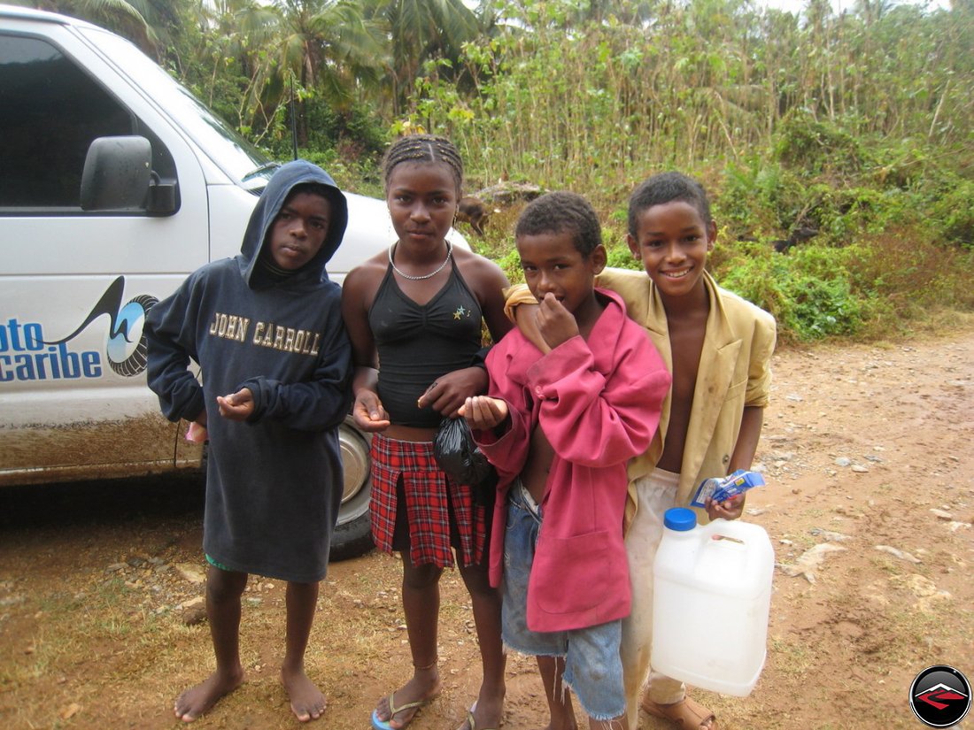 caribbean children share a bag of peanuts