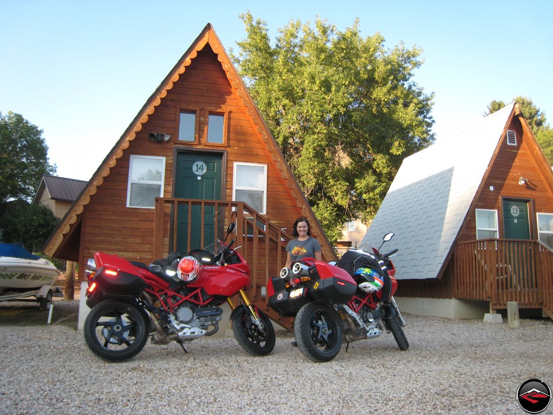 Two Ducati Multistrada motorcycles parked in front of Camper cabins in Hulett Wyoming