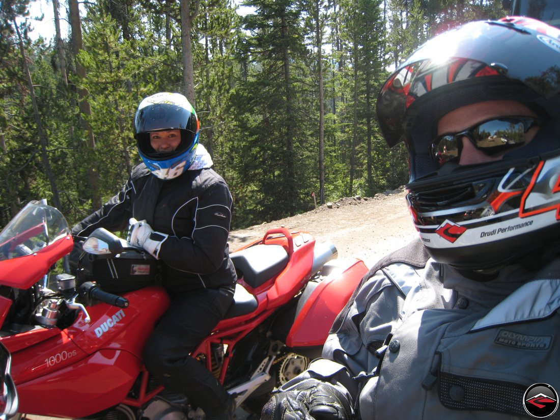 Man and a woman riding through Yellowstone National Park on Ducatis