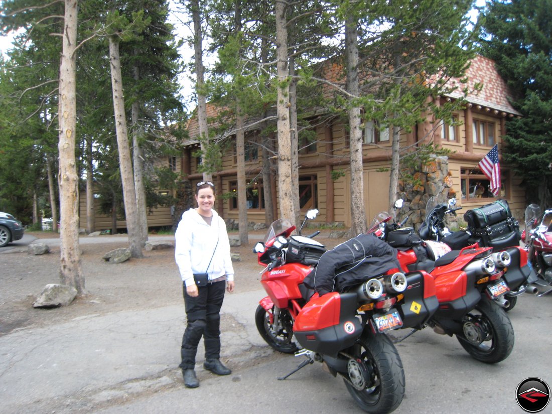 pretty woman at fishing bridge in Yellowstone National Park, standing next to parked motorcycles