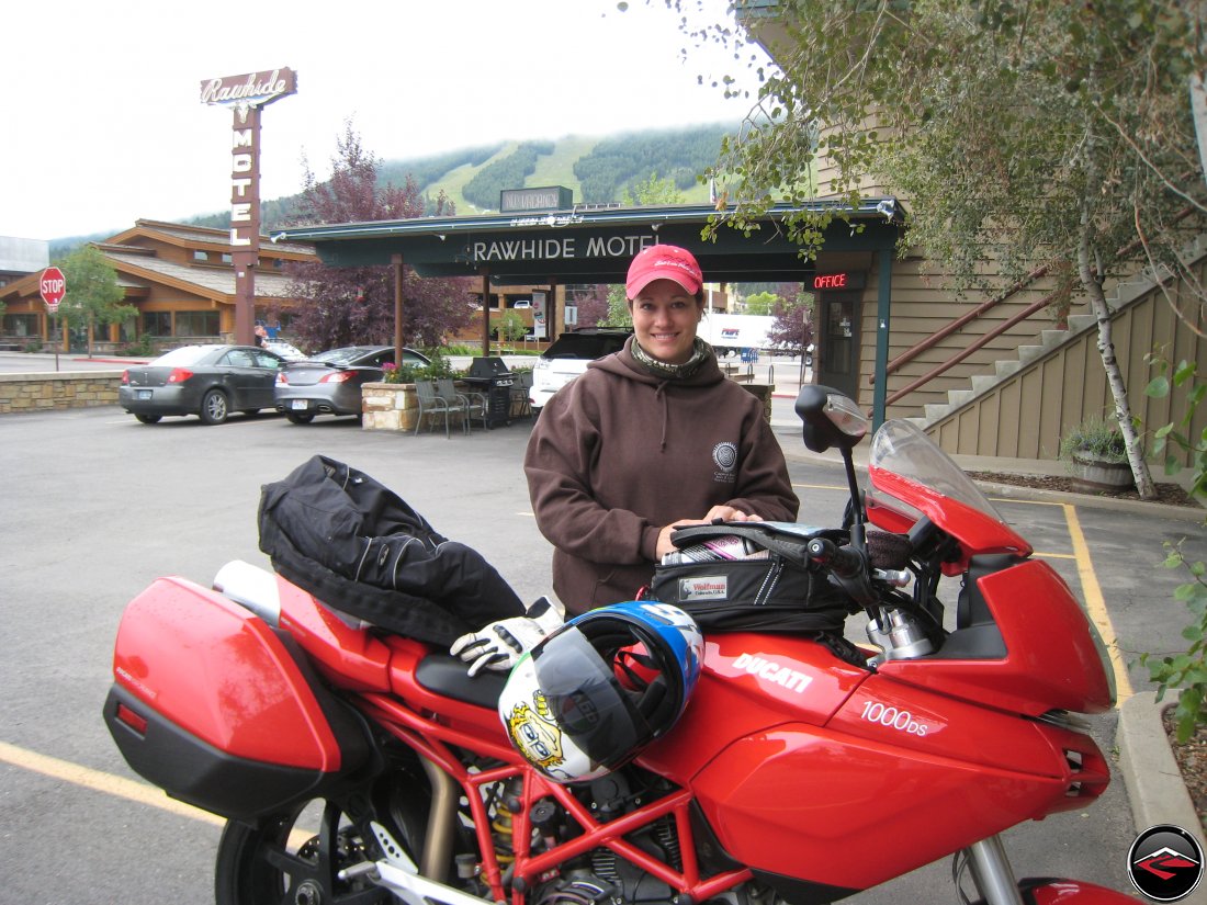 Pretty Girl standing behind her Ducati Multistrada Motorcycle at the Rawhide Motel in Jackson Holy, Wyoming