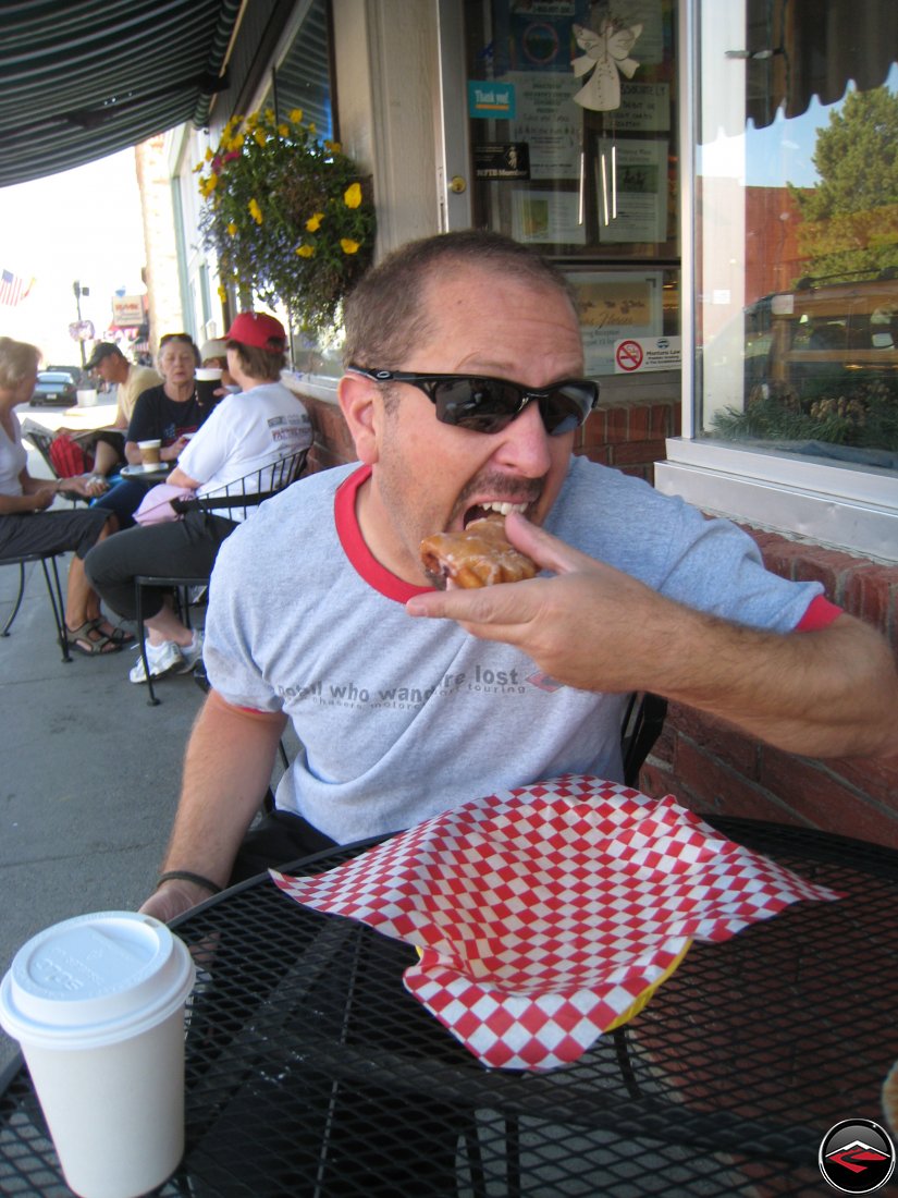 Man eating a bear claw donut