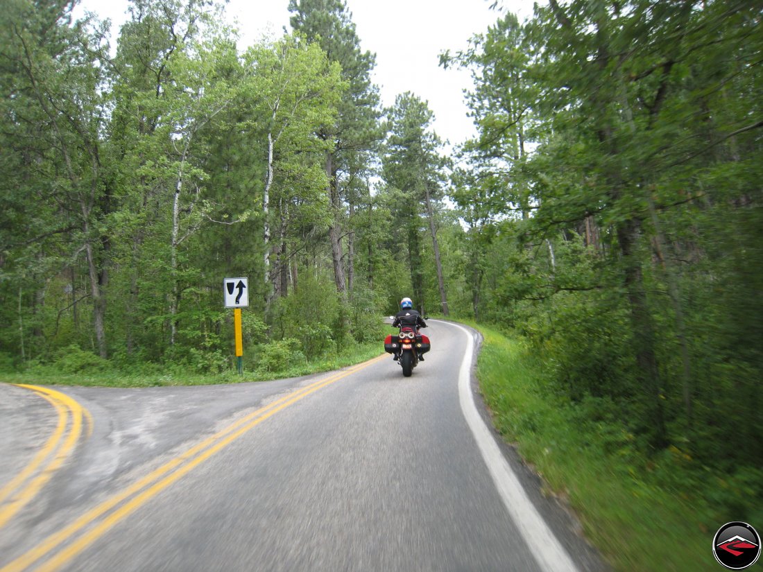 Ducati Multistrada Motorcycle Riding  on the Norbeck Scenic Byway in South Dakota where the road splits