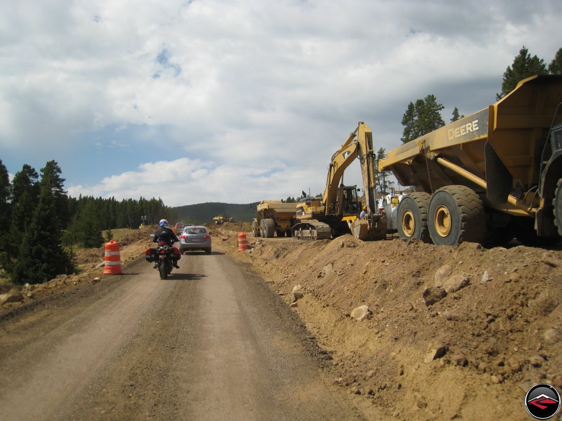 Ducati Mulitistrada Motorcycle riding through construction and past heavy equipment on the top of the Big Horn Mountains