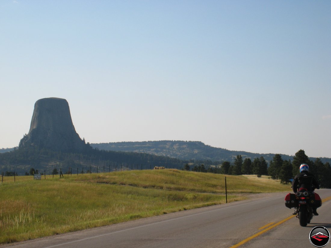 Motorcyclist on a Ducati Mulitstrada riding past Devils Tower in Wyoming