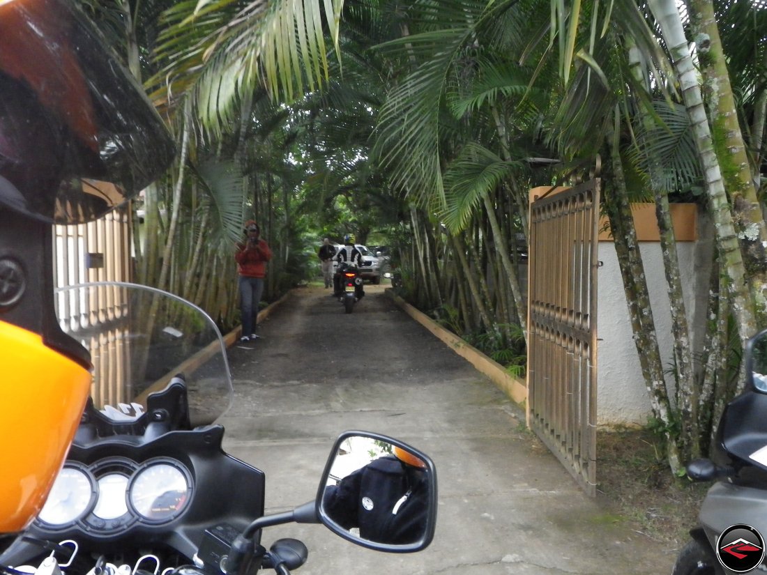 Leaving the compound in Jarabacoa on Suzuki V-Strom 650s, including riding past the steel driveway gate