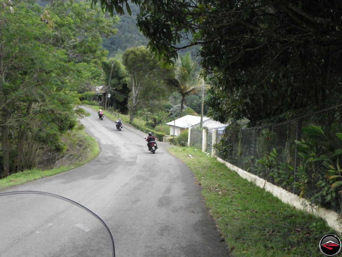 Riding motorcycles through a downhill, sweeping corner