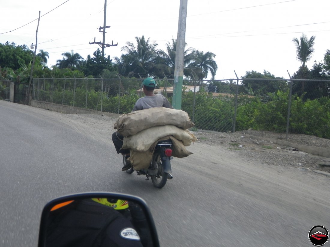 Third world motorcycle hauling a heavy load of sacks in the Dominican Republic - Bikes of Burden