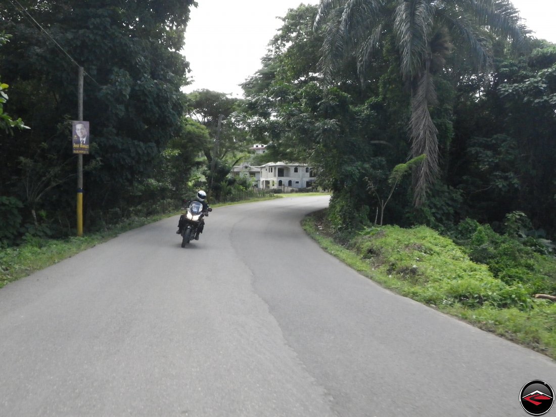 Riding a motorcycle through a sweeping bend on perfect asphalt on Highway 5 on the north coast of the Dominican Republic