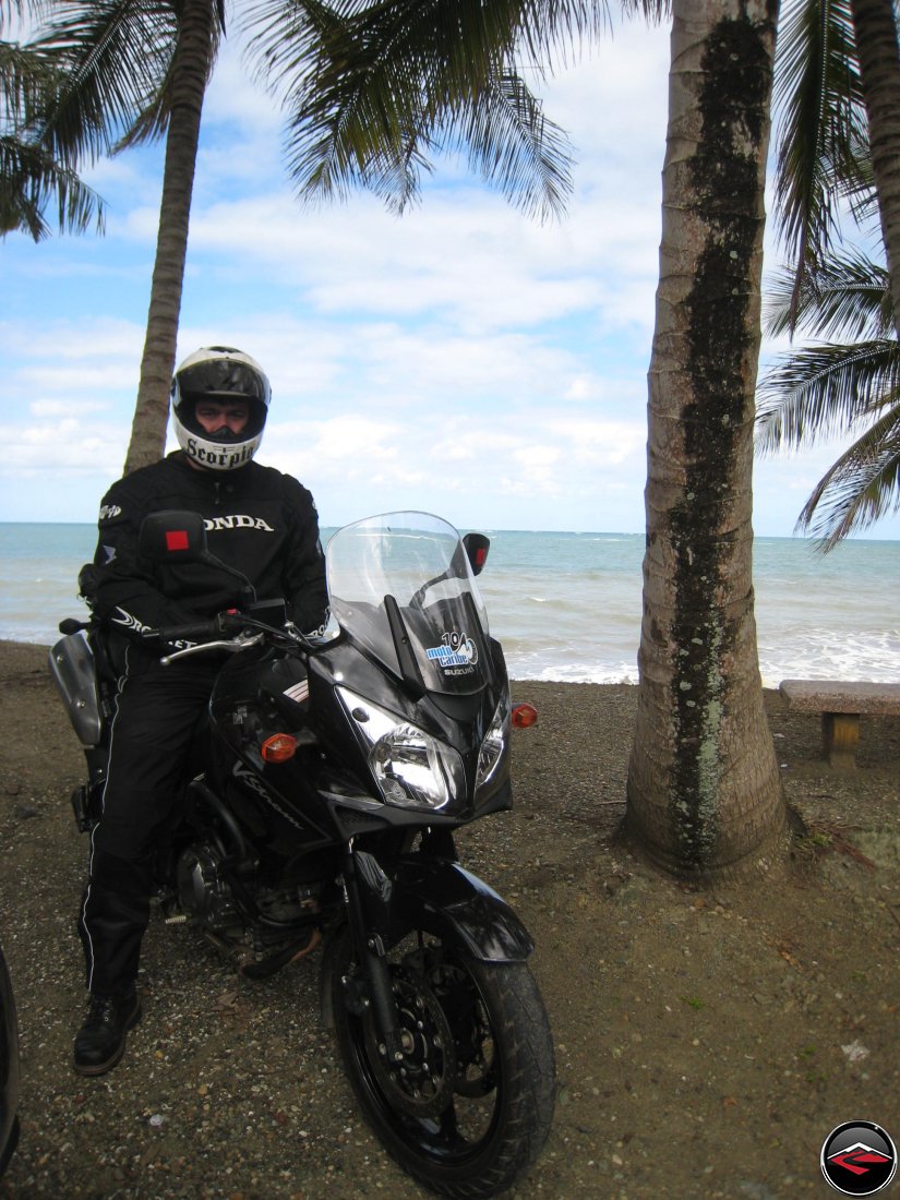 Warren wearing a Scorpion Helmet and wearing a Honda coat while on his Suzuki V-Strom 650