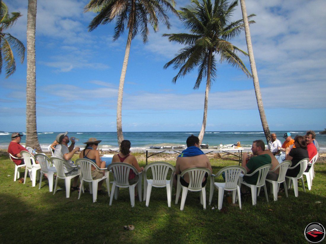 Sitting in lawn chairs on the beach eating lunch whlie enjoying pristine views of warm caribbean waters