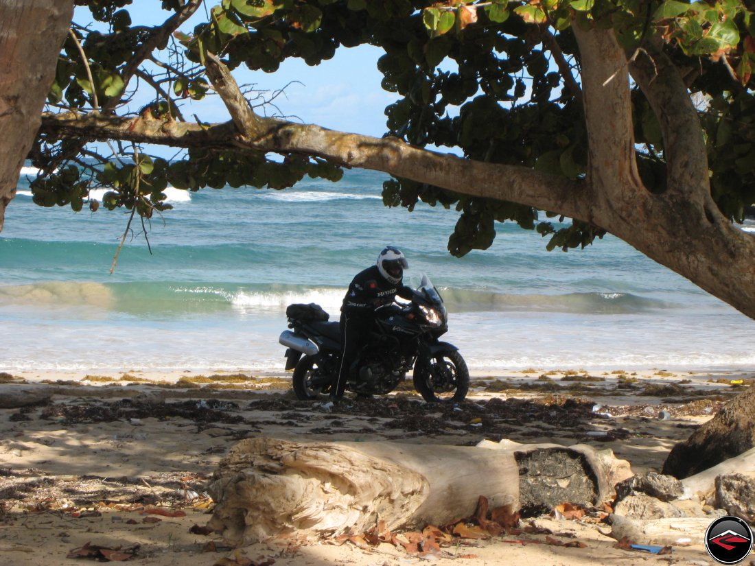 Man gets motorcycle stuck in the sand on the beach in the caribbean