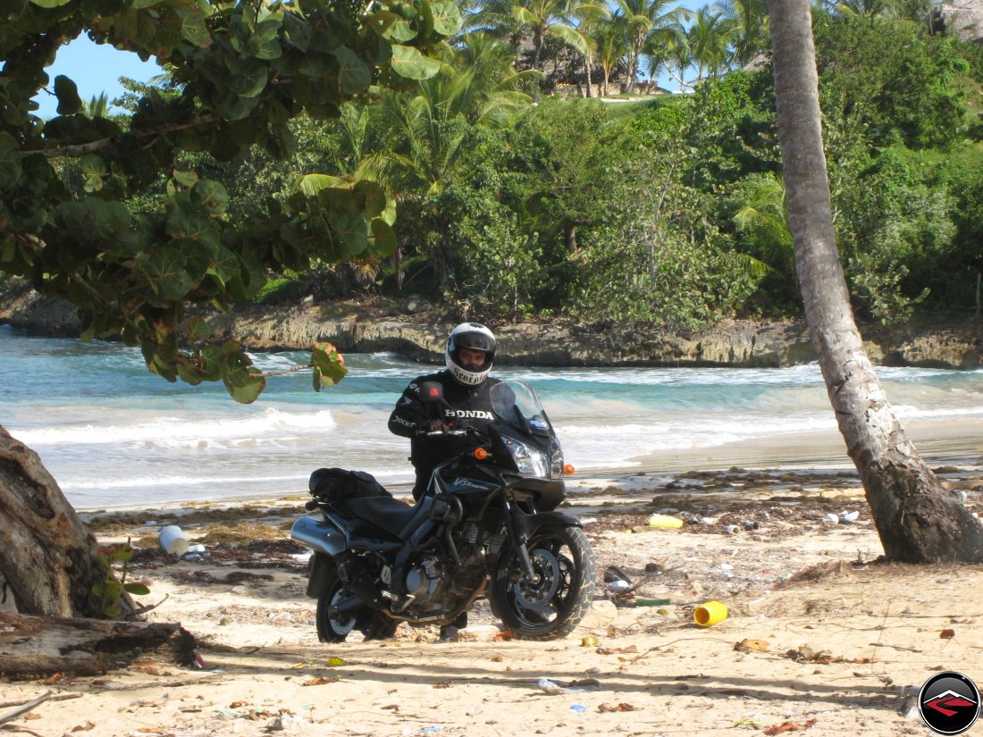 Man with motorcycle on the beach in the caribbean