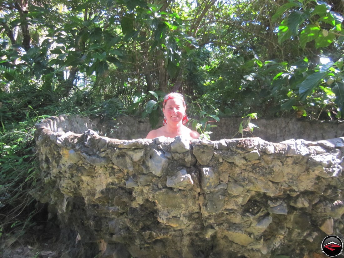 naked woman in a stone cauldron