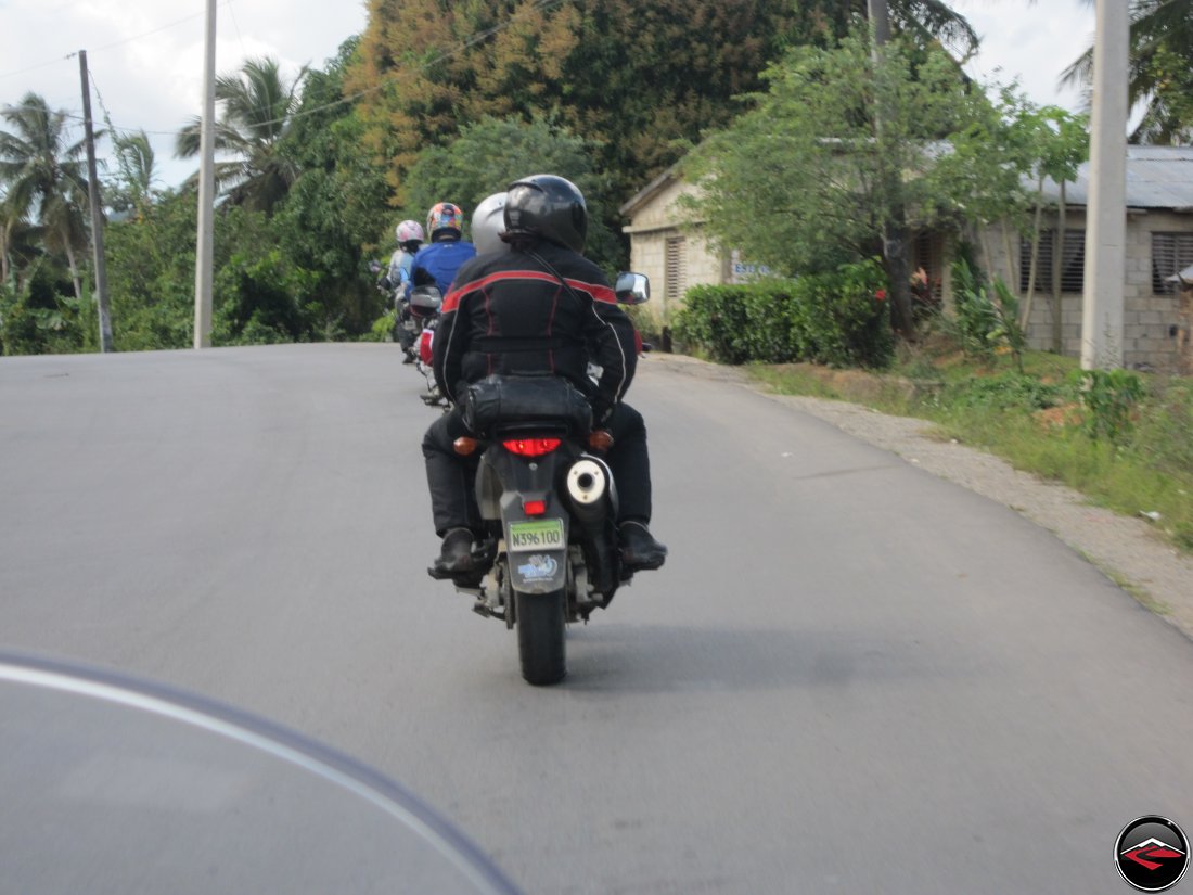 Motorcycles riding over a horizon on a caribbean island