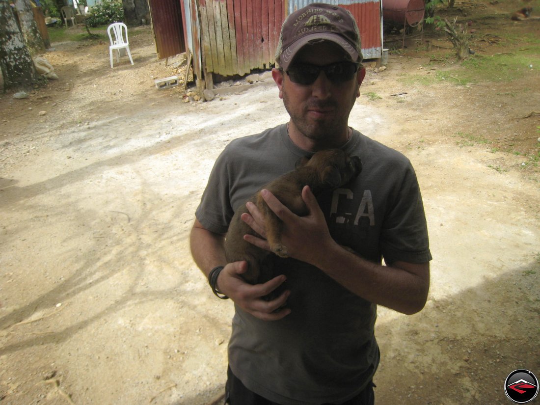 Man holds a stray puppy in the dominican republic
