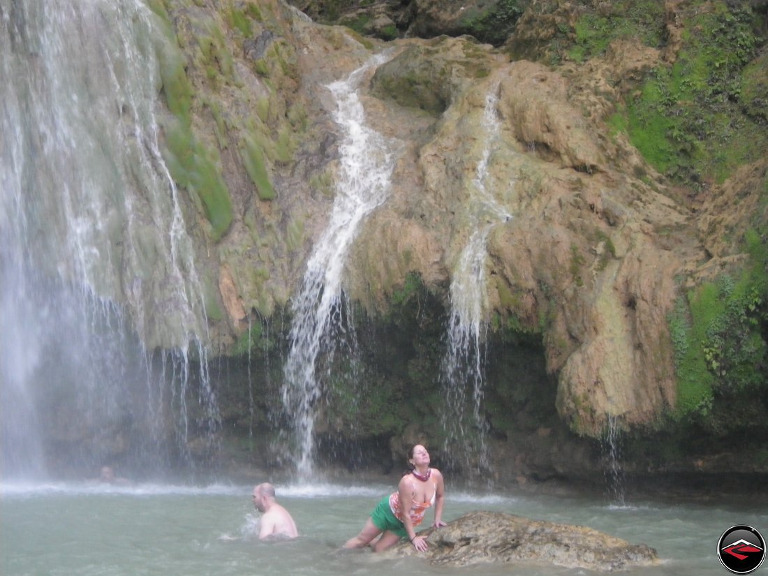 woman posing like a mermaid in front of a waterfall Cascada El Limon Dominican Republic