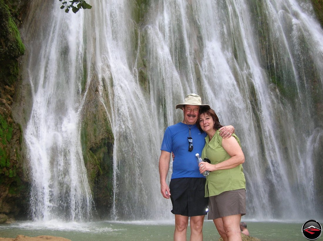 man and woman standing in front of a waterfall Cascada El Limon Dominican Republic