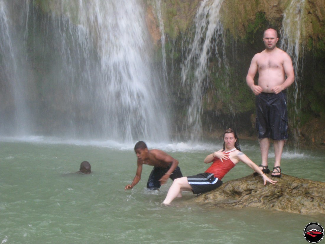 Woman posing like a pirate princess in front of a waterfall Cascada El Limon Dominican Republic