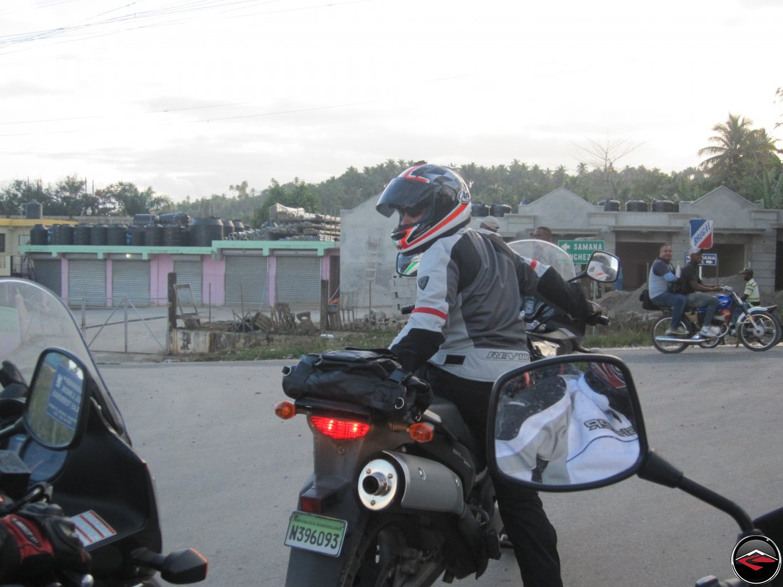 Man on a stopped motorcycle looking behind him